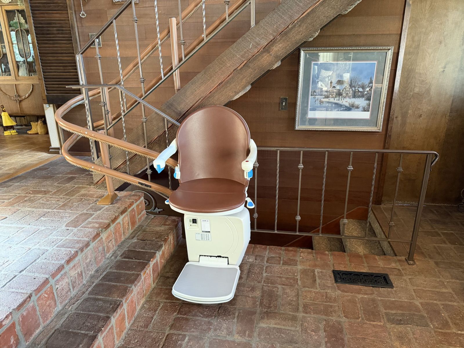 Curved stairlift installed on a wood staircase