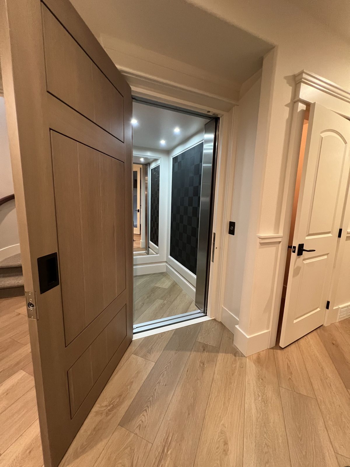Home elevator with wood-paneled door